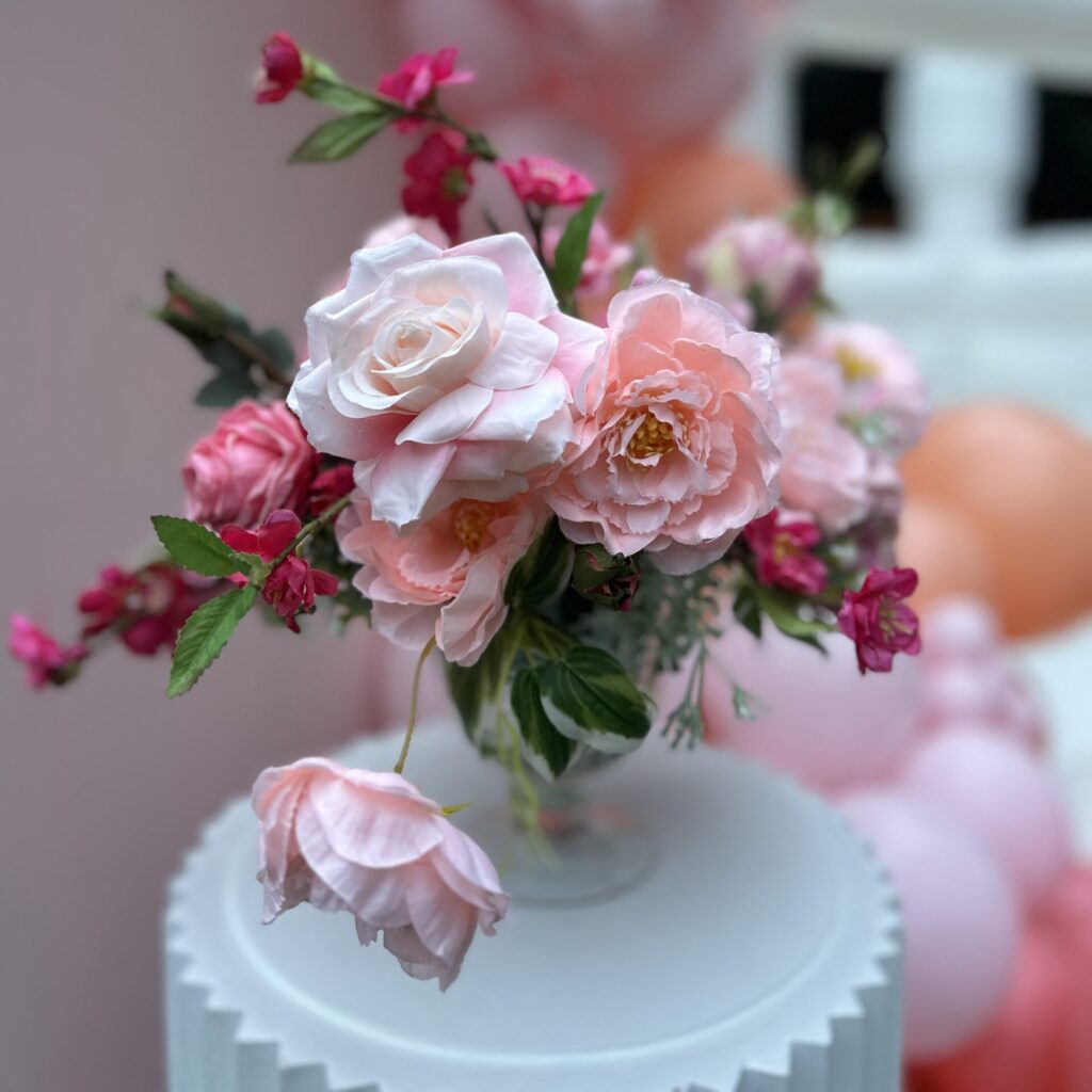beautiful petite floral arrangement with pink flowers. Placed on a kids table for kids seating for a wedding in snohomish & king county.