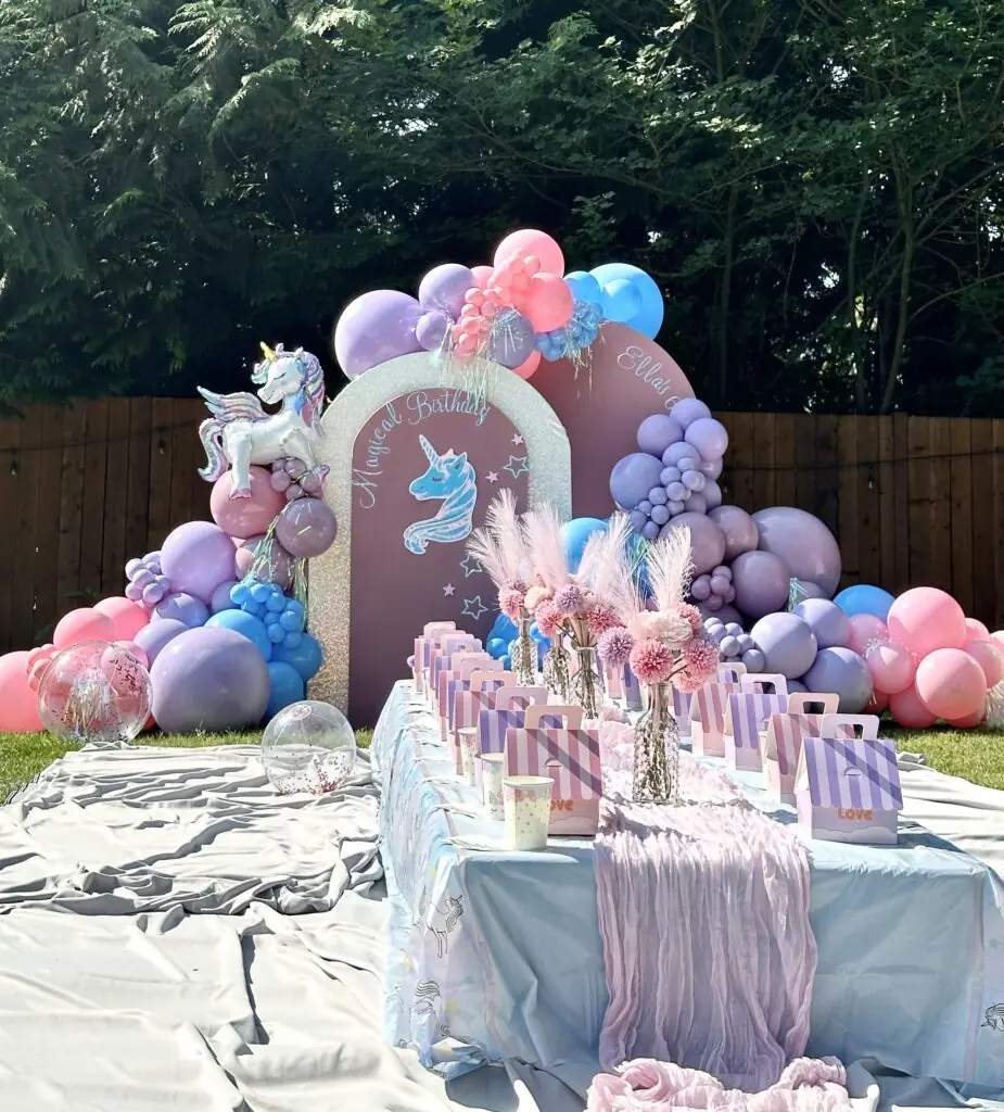stunning backdrop setup for instagram photos for a little girls birthday party in snohomish county & king county. Featuring custom unicorn props, backdrop arches, rainbow arch, custom vinyl signage, balloon garlands, petite floral arrangement & linen tabletop decor for kids seating from bradbury events.