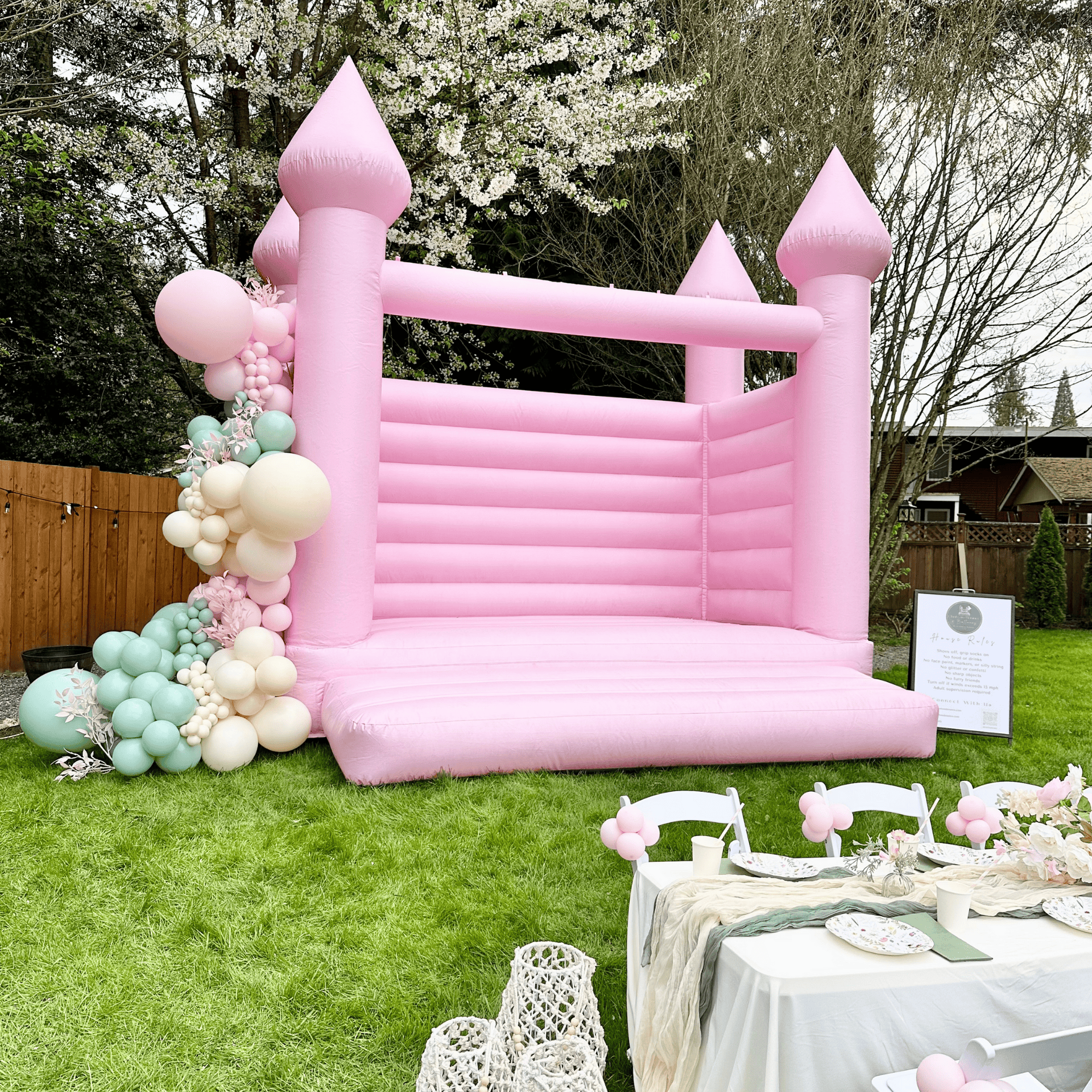 Luxury bounce house rental in lake stevens- bounce castle rental in lake stevens with pastel bounce house castle and balloon garland for bridal shower and barbie birthday party fun