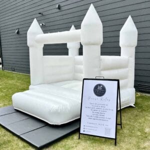White castle bounce house with posted rules for luxury party rentals in Snohomish and King County