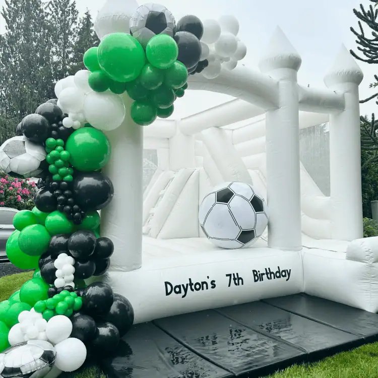 luxury bounce house rental in mukilteo with balloon garland for kids birthday party