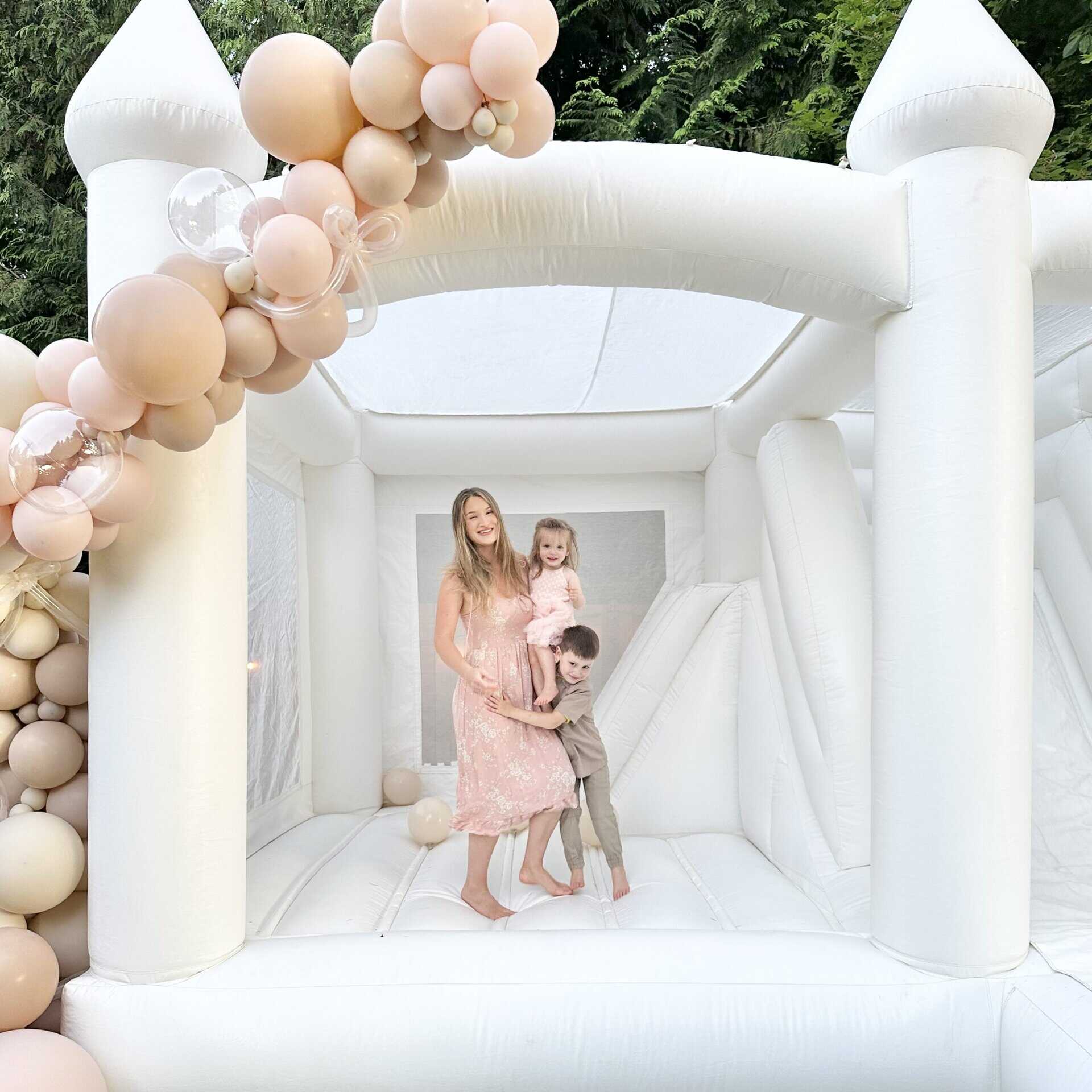 Luxury bounce house rental in snohomish county - white bounce castle with balloon garland - family bouncing for kids birthday and upscale events in bellevue
