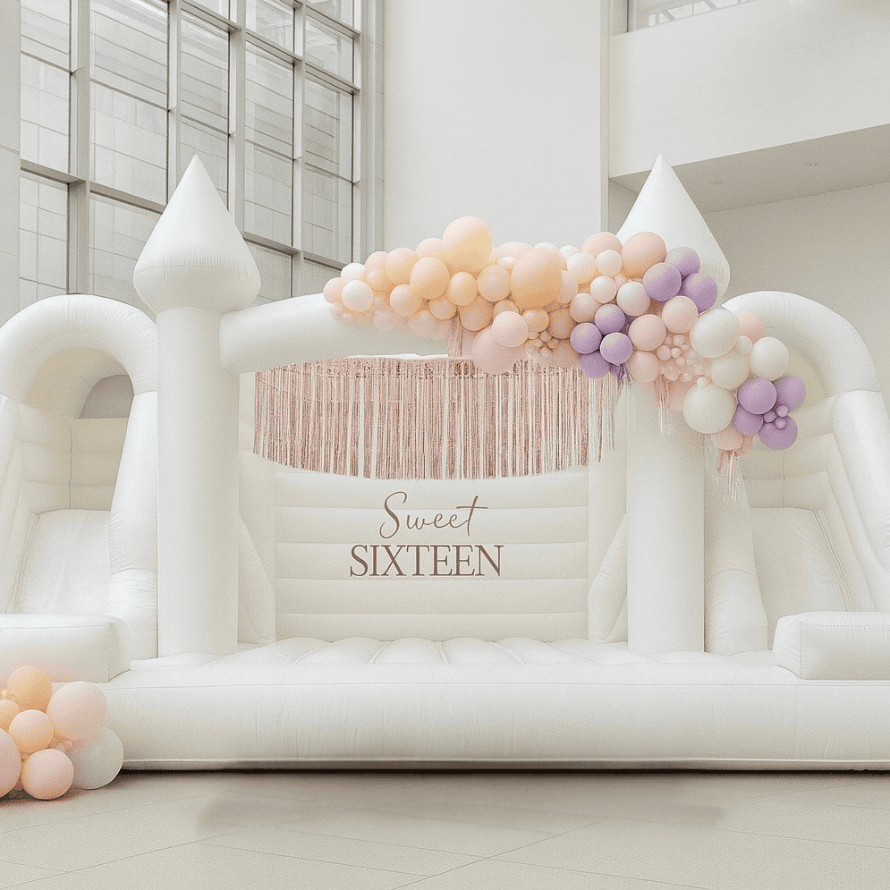 White Bounce Castle with balloon styling, vinyl signage and fringe decor for sweet 16 birthday party in snohomish county and king county