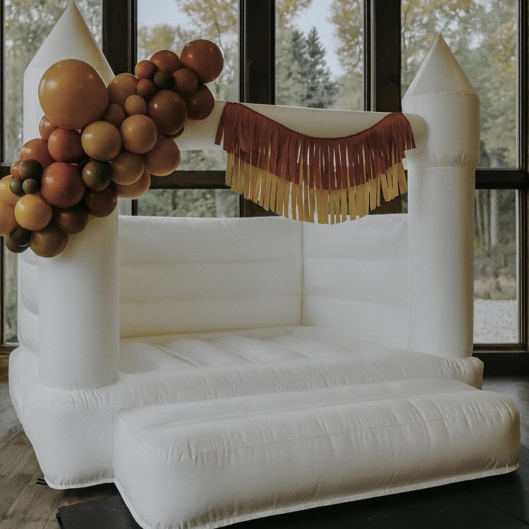 Toddler bouncer "Thaya" - indoor bounce house rental with fall themed balloon garland and fringe decor for party in Snohomish County & King County