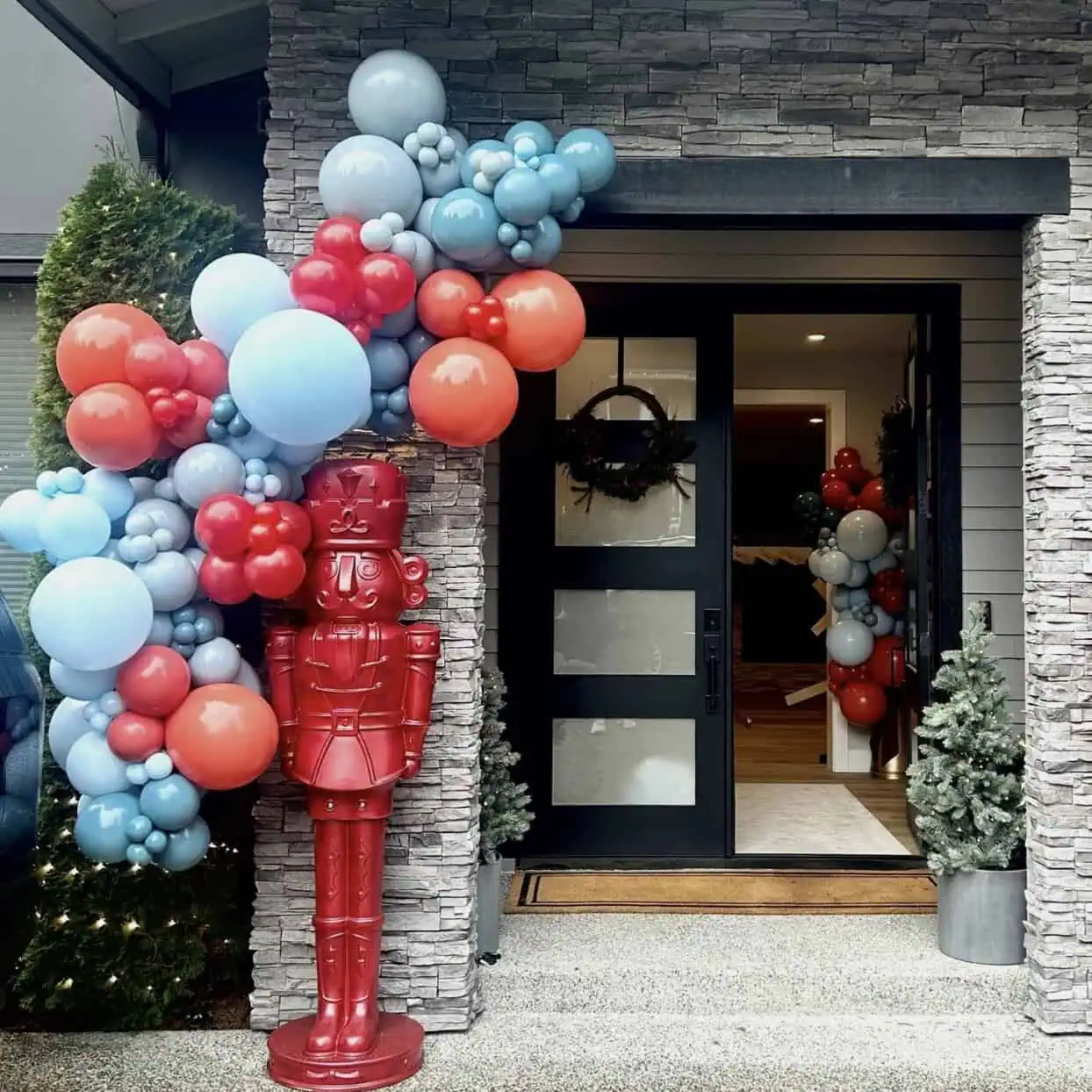 Holiday balloon garland framing a front door