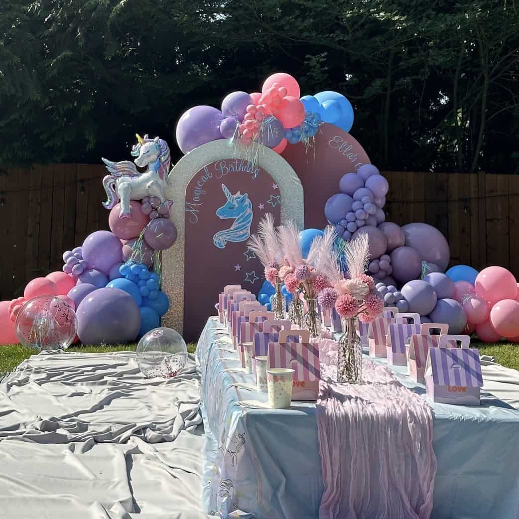 Photo: kids party backdrop wall with bright balloons and a styled kids table