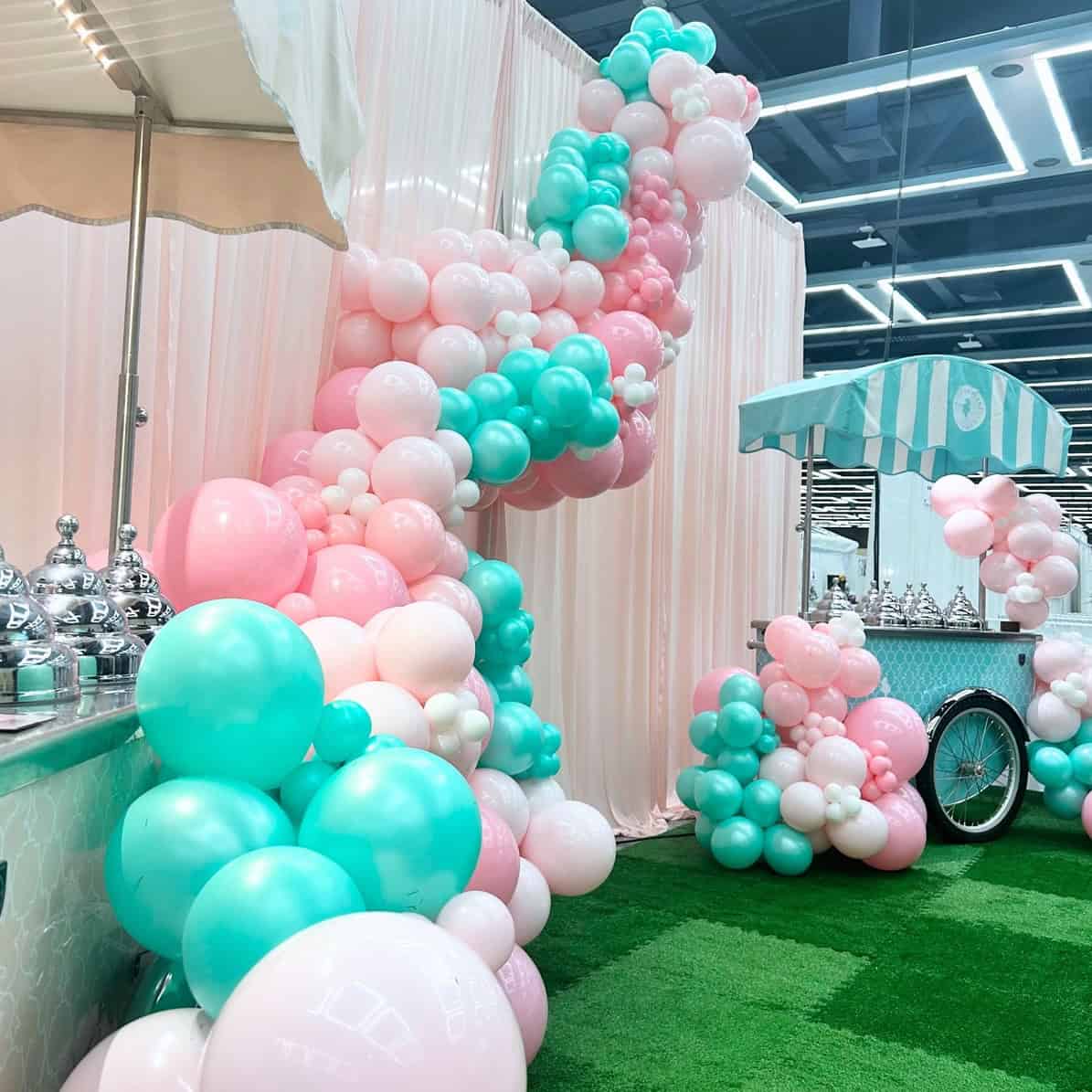 Pastel balloon garland and balloon decor at for a corporate event at the seattle wedding expo for Nutty Squirrel Gelato