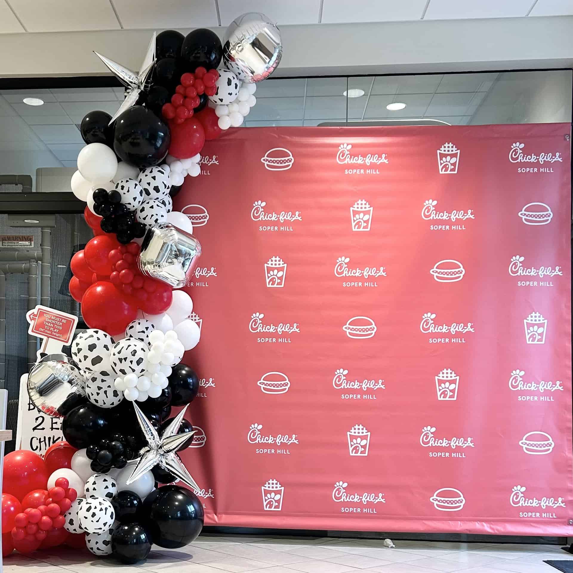 Photo: branded backdrop and balloon decor for a small business event - chick-fil-a grand opening