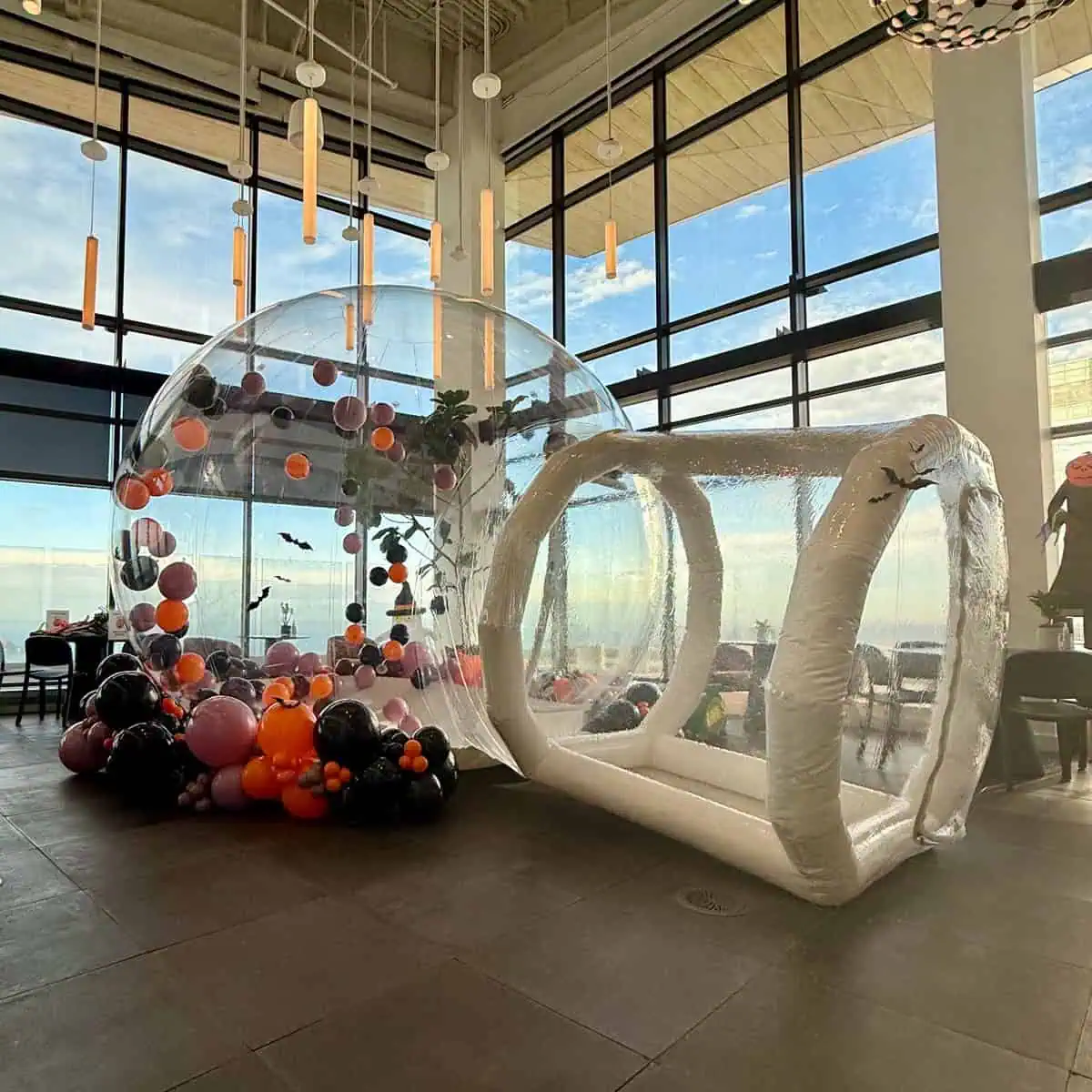 Clear Bubble House filled with orange, black and purple balloons for a Halloween party at a Seattle venue
