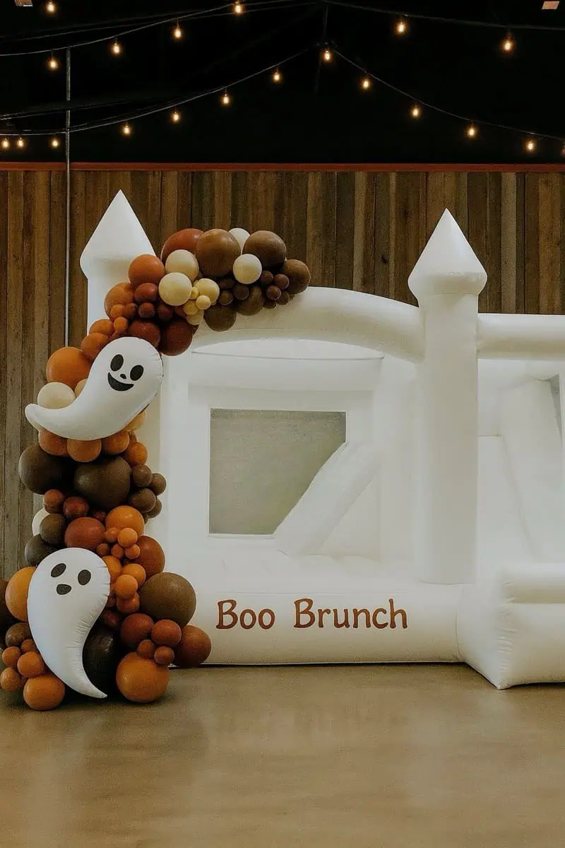 St. Helens white bounce castle with a slide, ghost balloons and a Boo Brunch sign for a Halloween brunch