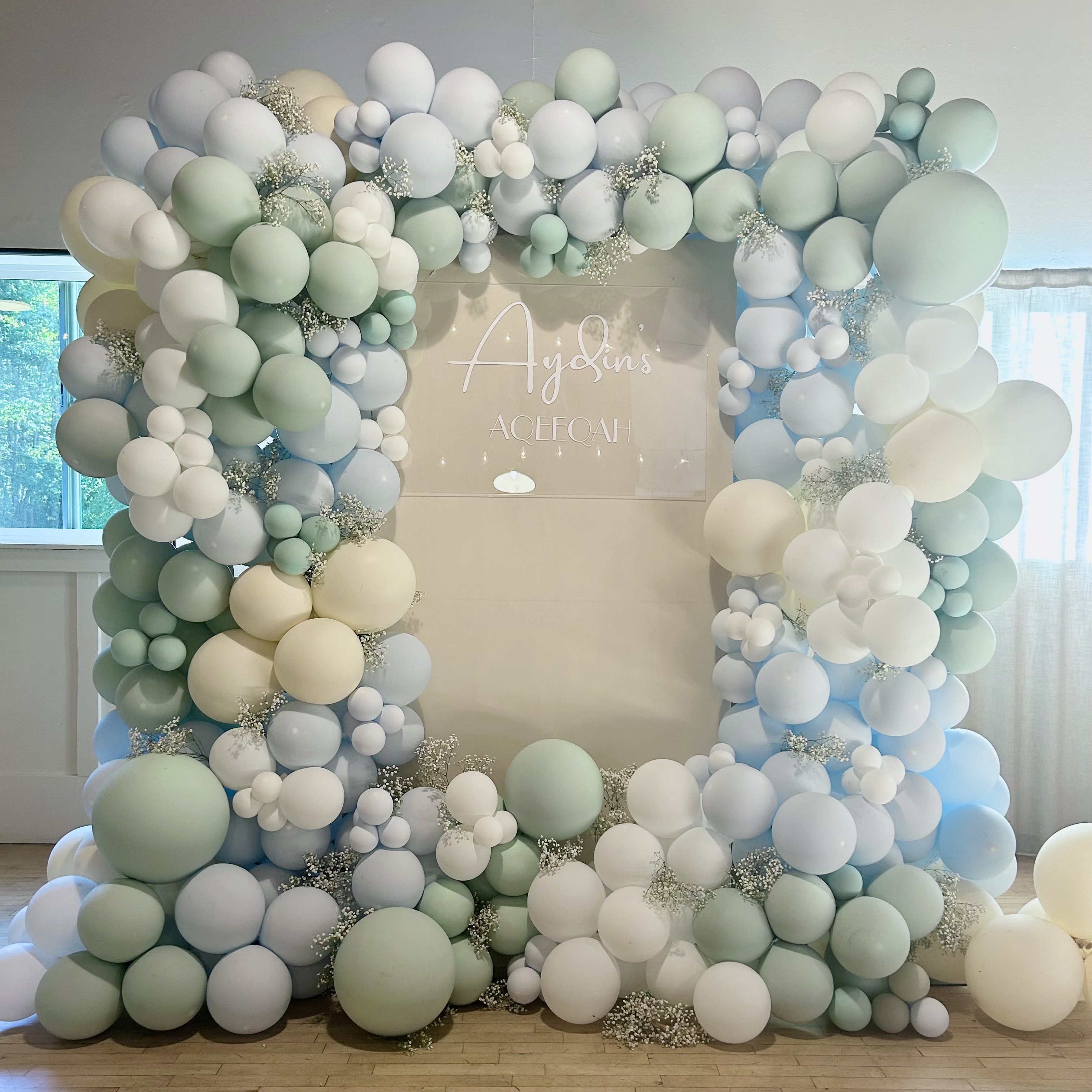 Mint, powder blue, and ivory balloon garland and custom backdrop for a aqeeqah at Vasa Park Resort in Bellevue, WA