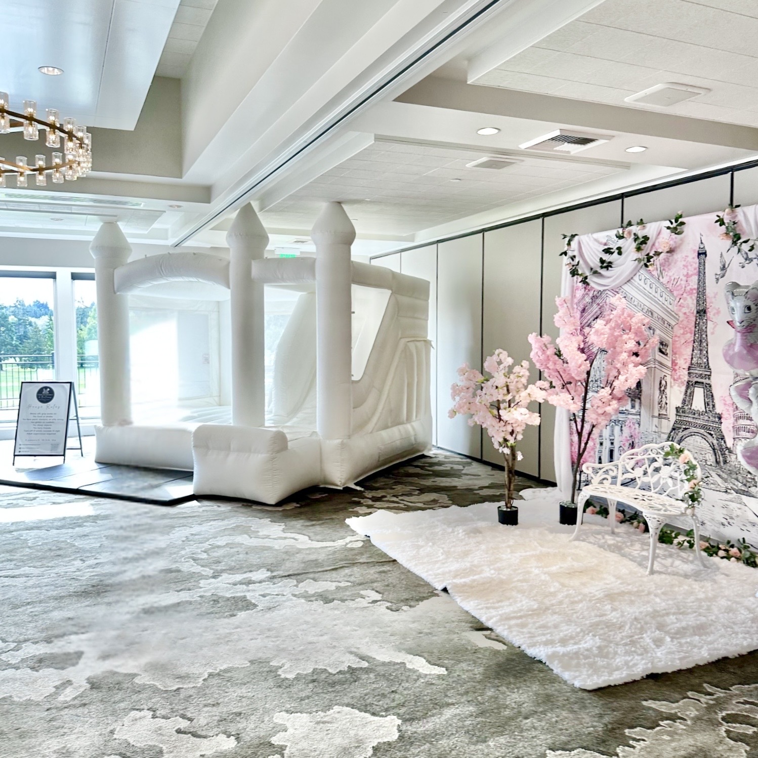 St Helens white bounce house with white and blush balloon garland for a birthday at Overlake Country Club in Bellevue, WA