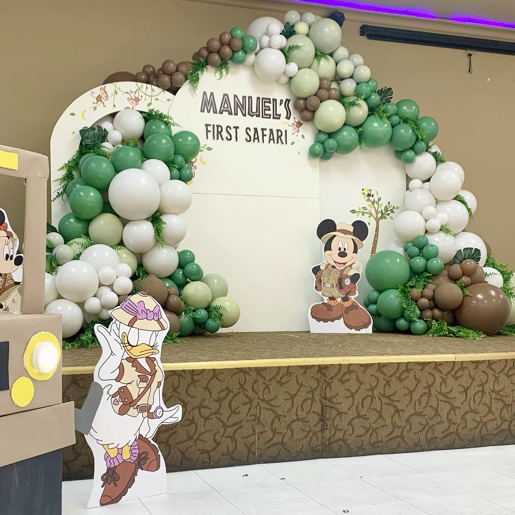 Emerald, white, and sand balloon garland and safari themed backdrop for a first birthday at Royal Banquet and Conference Hall in Everett, WA