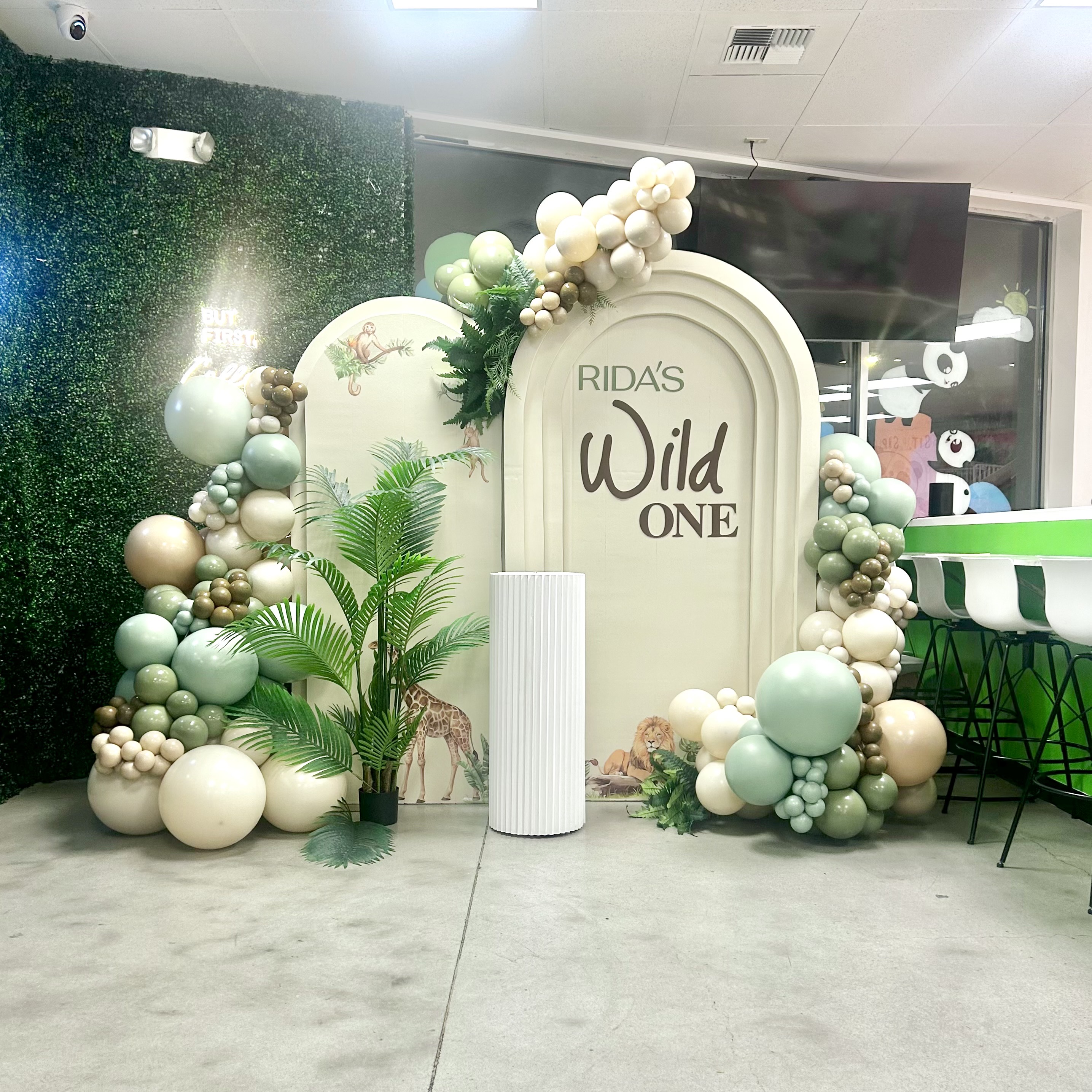 Sage, ivory, and sand balloon garland and wild themed backdrop for a first birthday at Little Pandas Play Cafe in Everett, WA