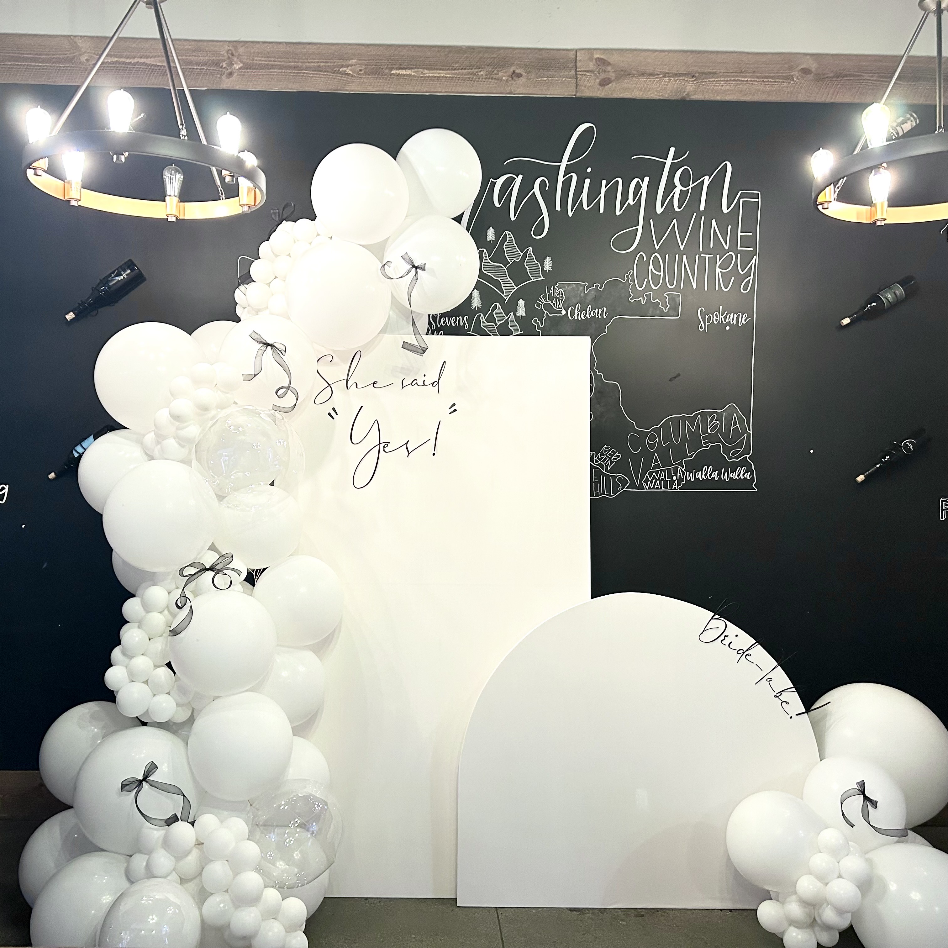 White balloon garland and custom backdrop for an engagement party at Rustic Cork in Lake Stevens, WA
