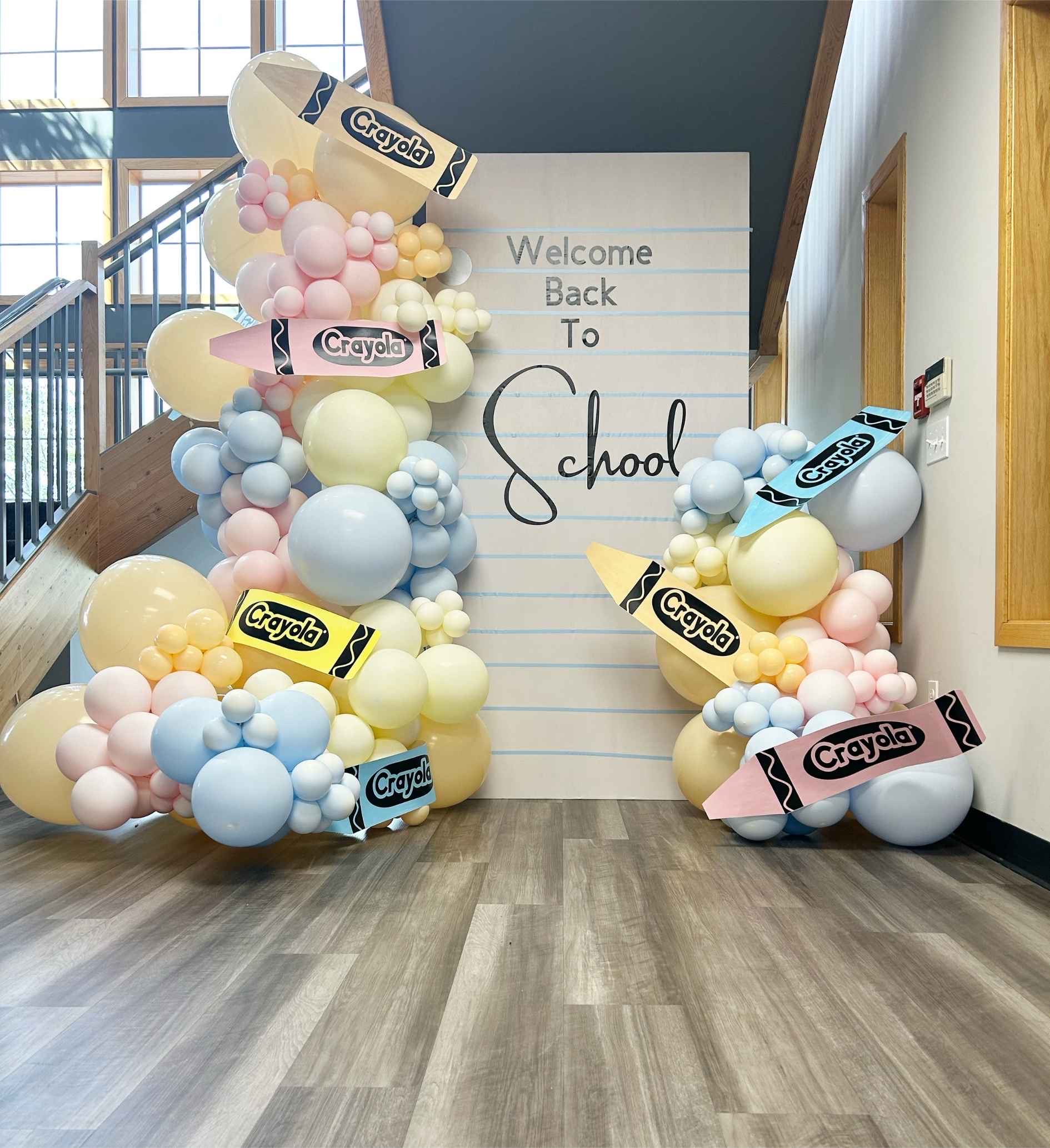 Blush, powder blue, and ivory balloon garland and school themed backdrop for a Back to School at RockCreek Church in Marysville, WA