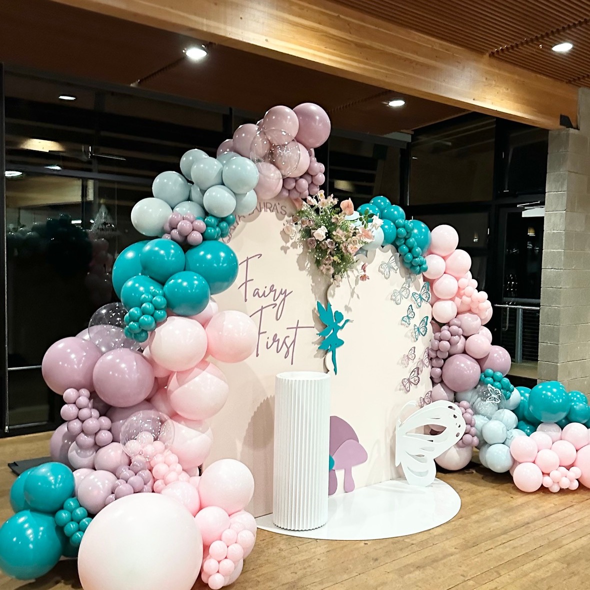 Luxury blush, dusty rose, and teal organic balloon garland with fairy themed accents for a first birthday backdrop in Monroe, WA