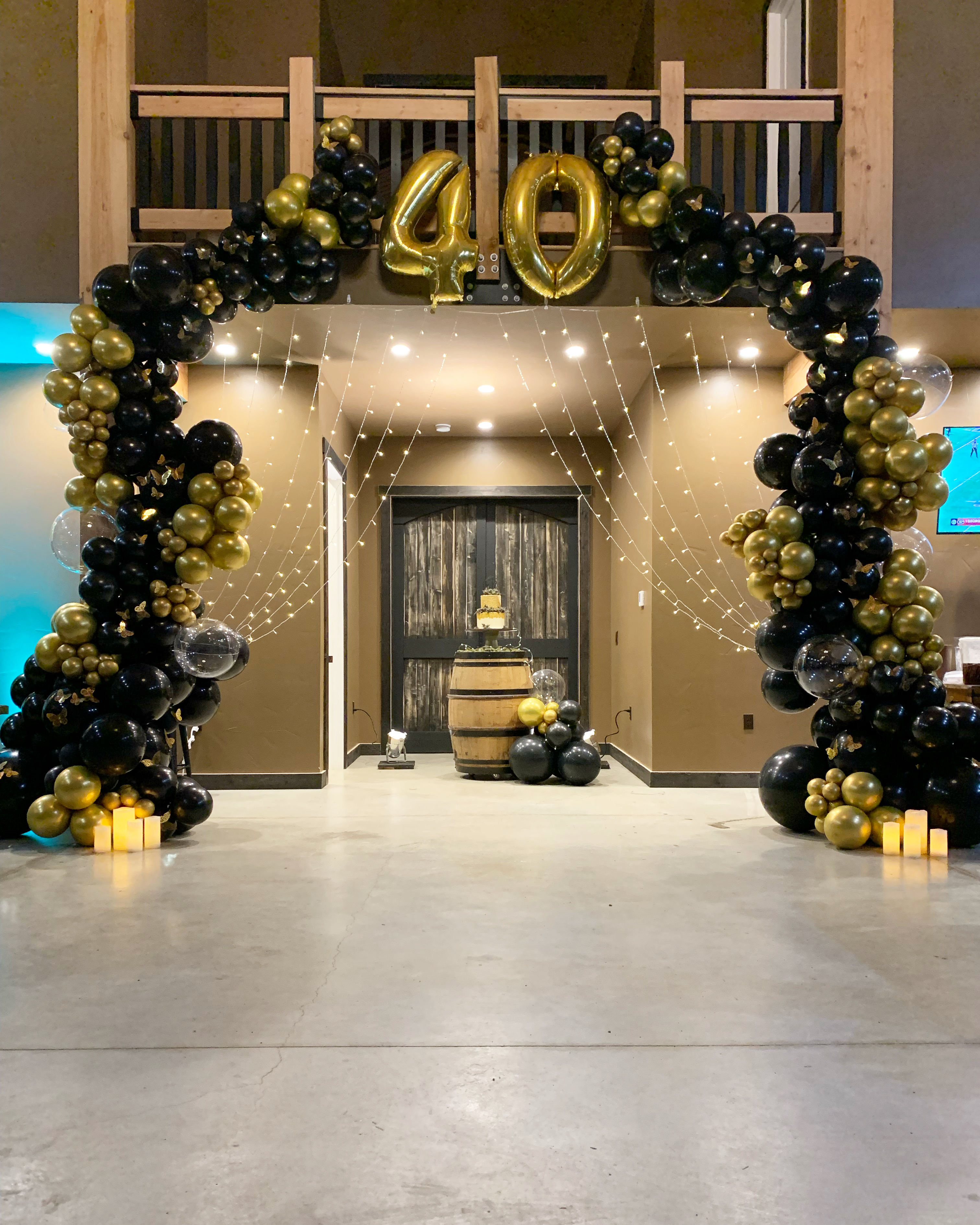 Black and gold balloon garland and custom backdrop for a 40th Birthday at The Lodge at Sonneveldt Vineyard in Monroe, WA