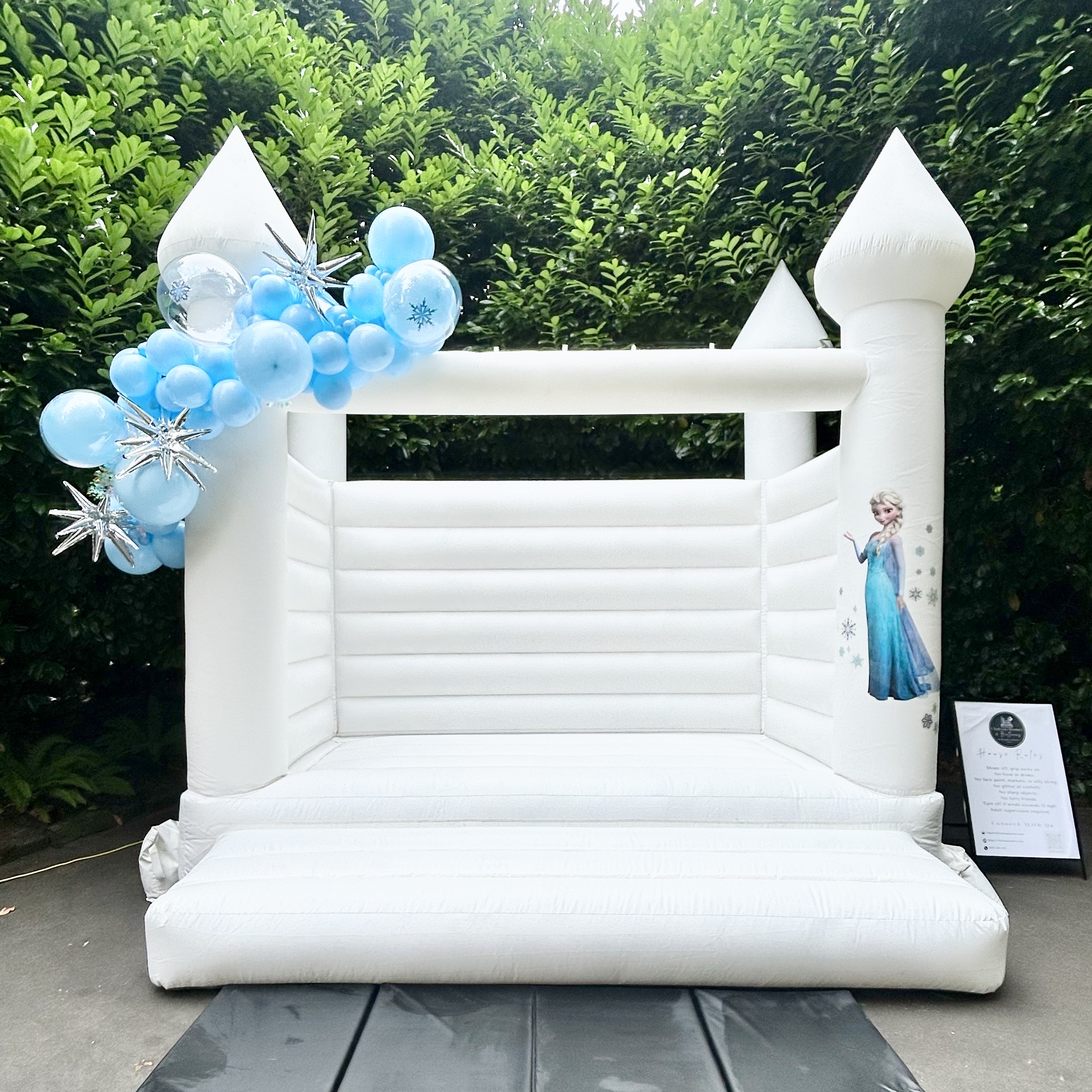 Magnolia white bounce house with powder blue, white, and chrome balloon garland for a birthday in Mukilteo, WA